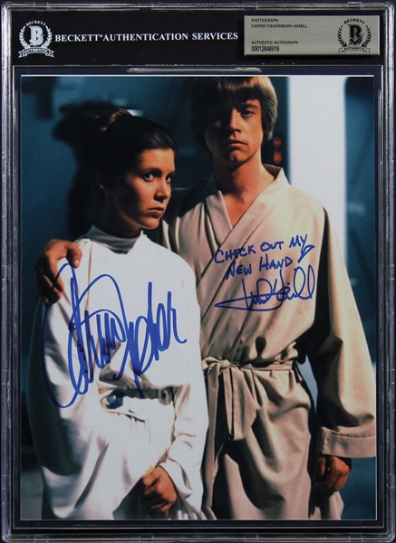 Star Wars: Mark Hamill & Carrie Fisher Signed 8" x 10" Photo with "Check Out My New Hand" Hamill Insc. (Beckett/BAS Encapsulated)