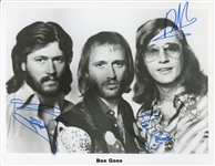 Bee Gees: Barry, Robin, and Maurice Gibb Signed 8 x 10 Photo (Epperson/REAL)
