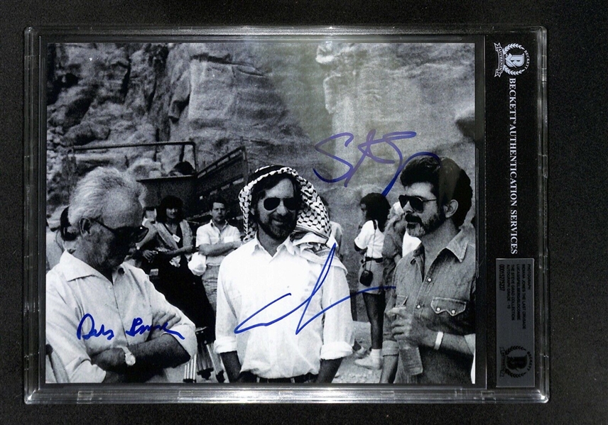 Indiana Jones: George Lucas, Steven Spielberg and Douglas Slocombe Signed 8" x 10" Photo from ROTLA Set with GEM MINT 10 Autographs! (Beckett/BAS Encapsulated)(Grad Collection)